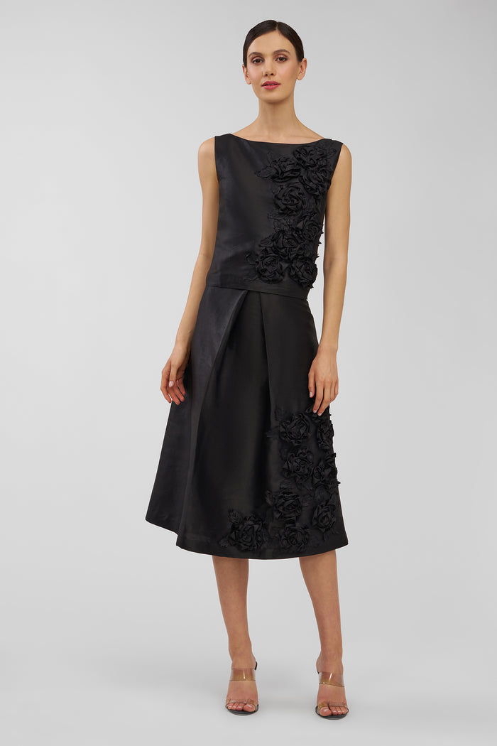 Black top and skirt with floral details on a white background